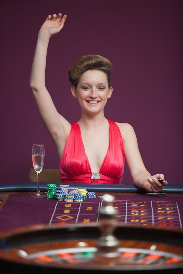 km777 login live-dealer studio with professional dealers at blackjack, roulette, and baccarat tables